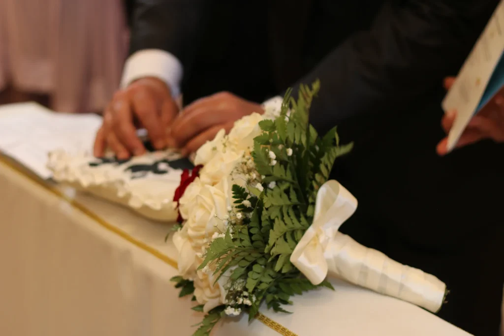 midsection bridegroom holding flower bouquet